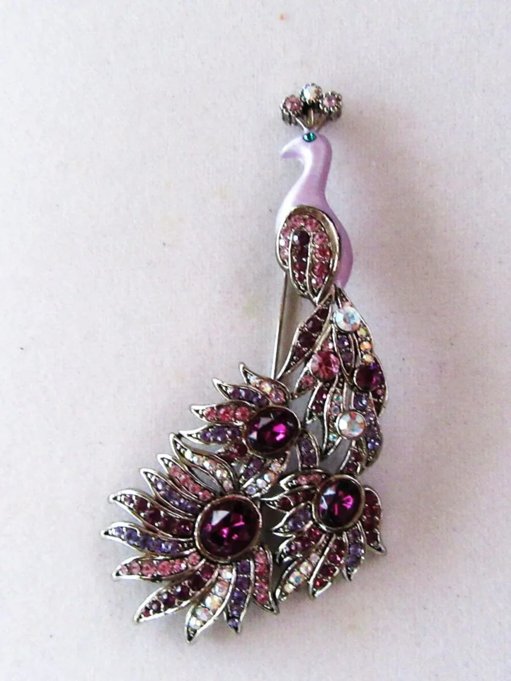 Peacock brooch with purple and aurora borealis rhinestones in silver setting